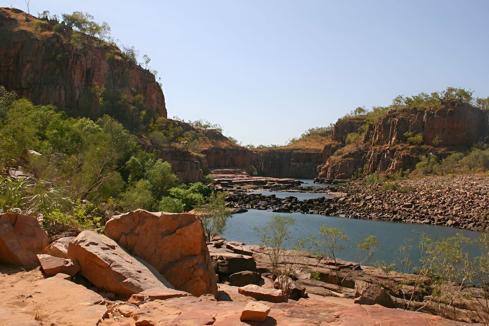 A Large Body Of Water Surrounded By Rocks And Trees — Lohman Contracting in Katherine, NT