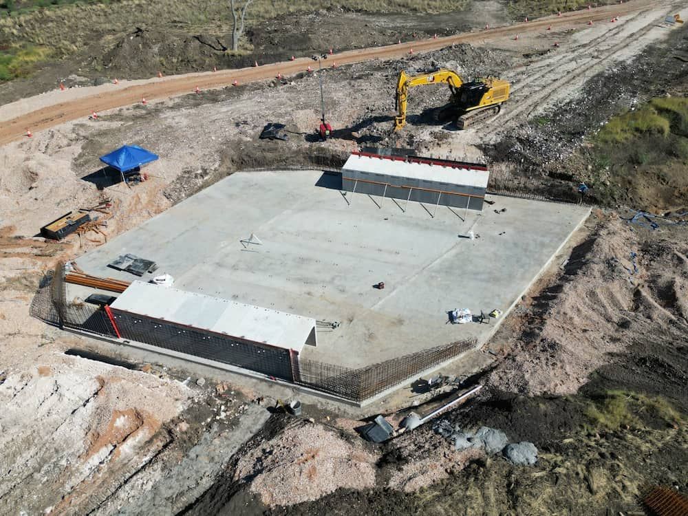 An Aerial View Of A Construction Site With A Yellow Excavator — Lohman Contracting in St George, QLD