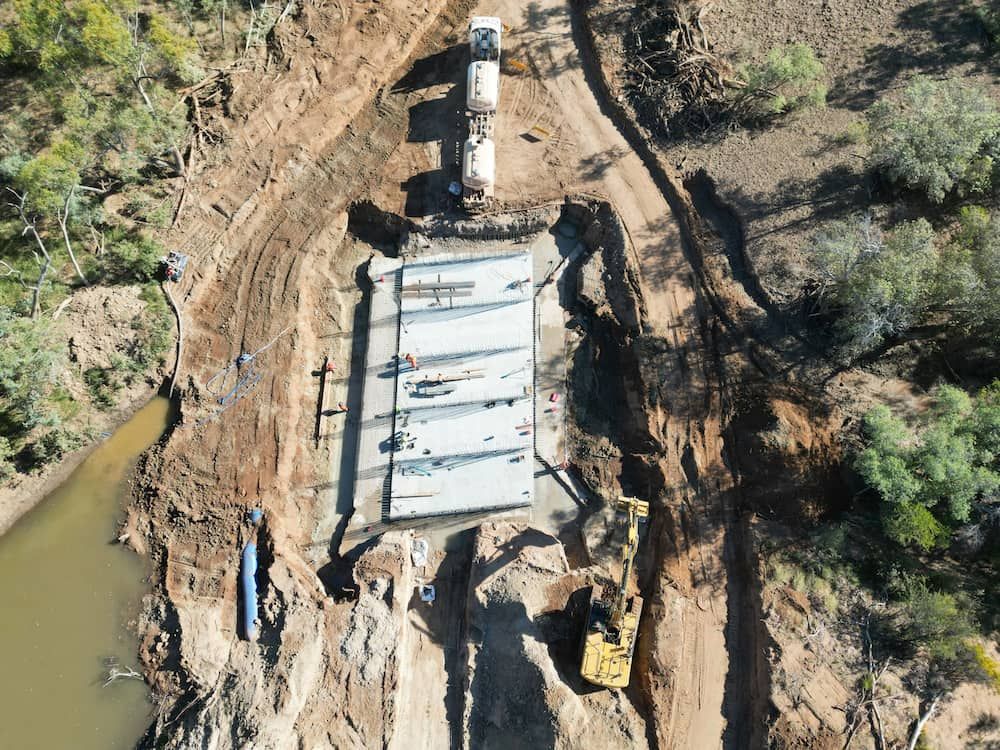 An Aerial View Of A Construction Site Next To A River — Lohman Contracting in Biloela, QLD