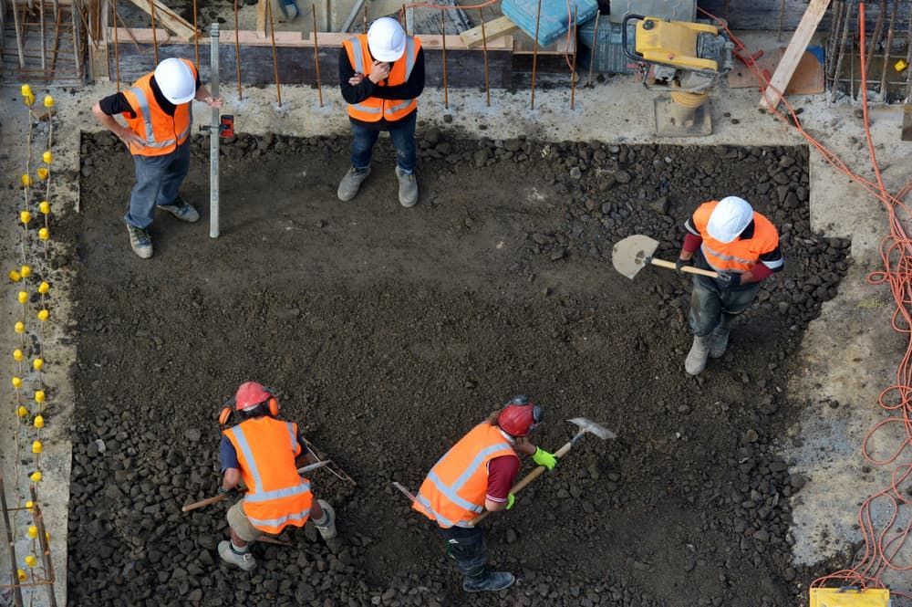 A Group Of Construction Workers Are Working On A Construction Site — Lohman Contracting in Emerald, QLD
