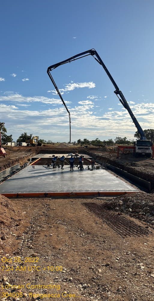 A Concrete Pump Is Being Used To Pour Concrete On A Construction Site — Lohman Contracting in Emerald, QLD