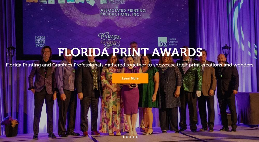 Group of people on stage at the Florida Print Awards.