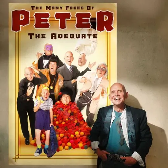 A man stands in front of a poster for peter the adequate