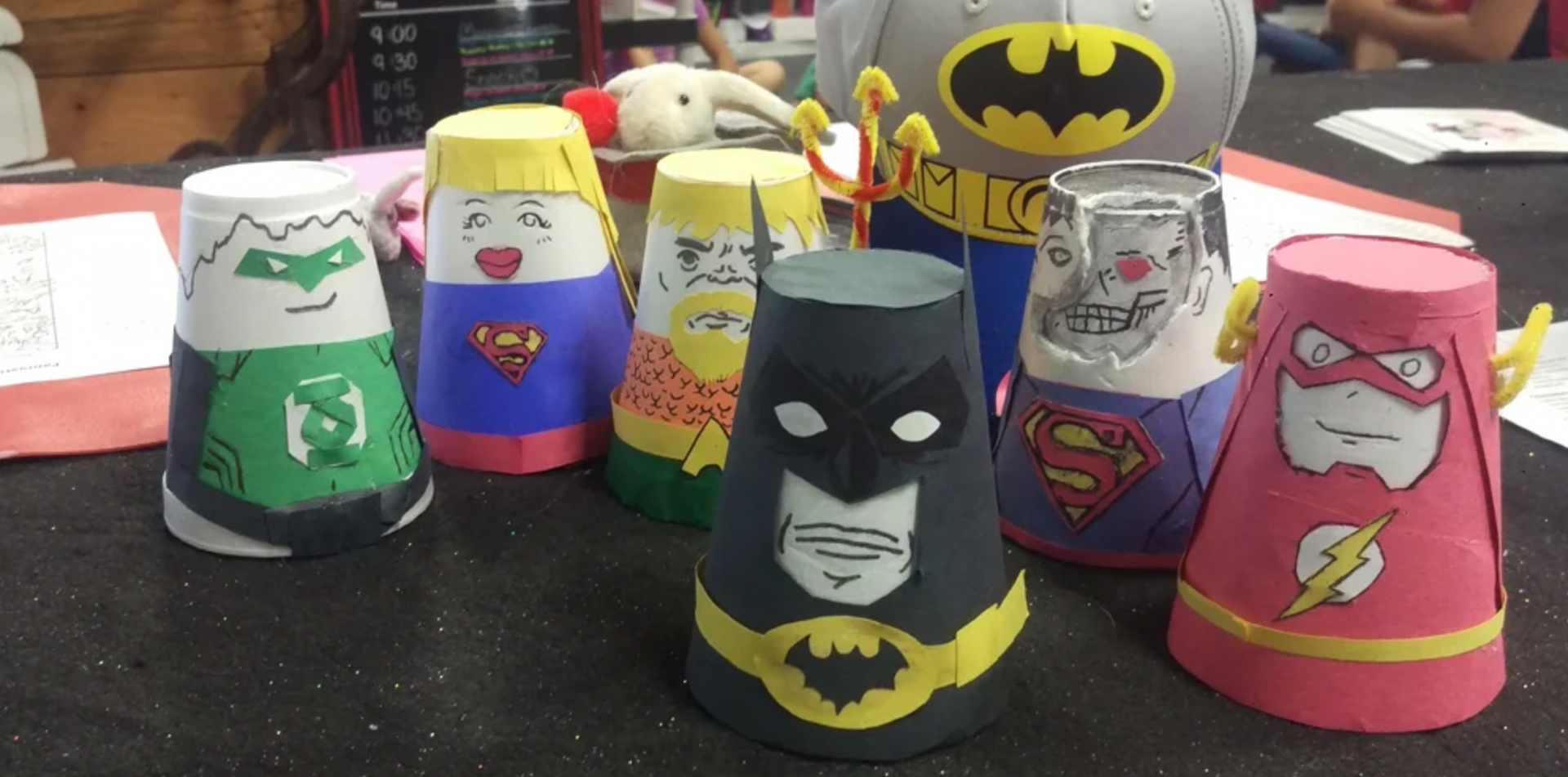 a group of superhero cups are sitting on a table