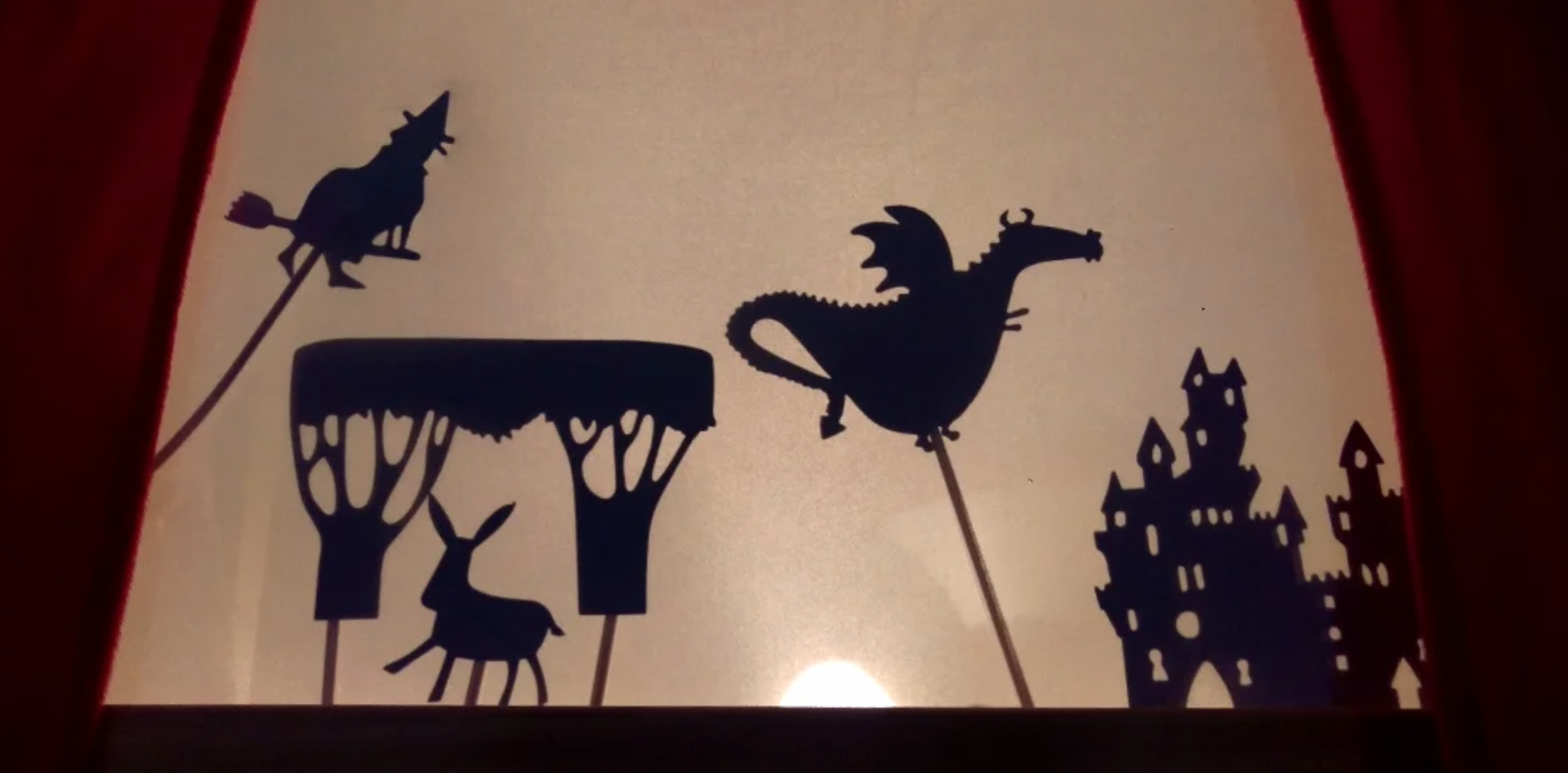 shadow puppets of a witch a dragon a deer and a castle