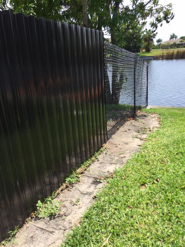 Privacy Fence with Grass and Water — Cape Coral, FL — Global Fence Inc.