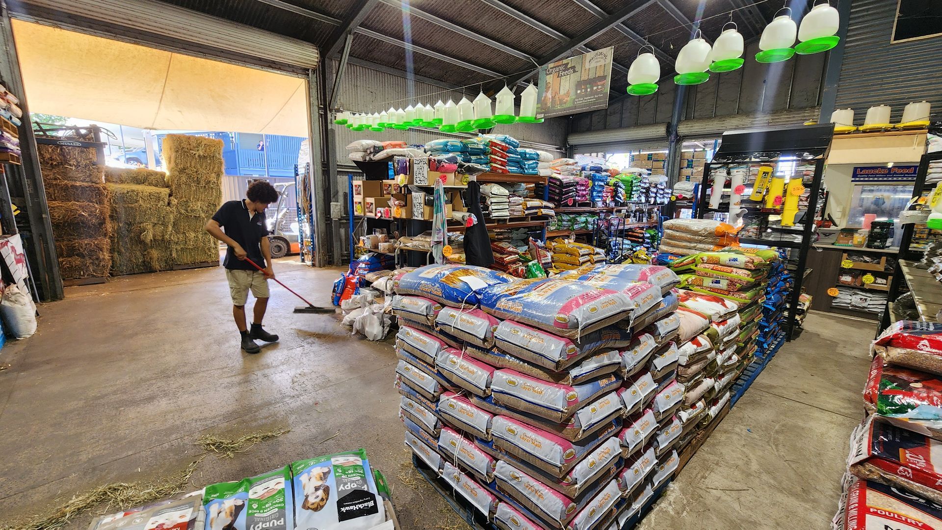 A Man Sweeping Out A Produce Store — Cooroy Produce In Cooroy, QLD