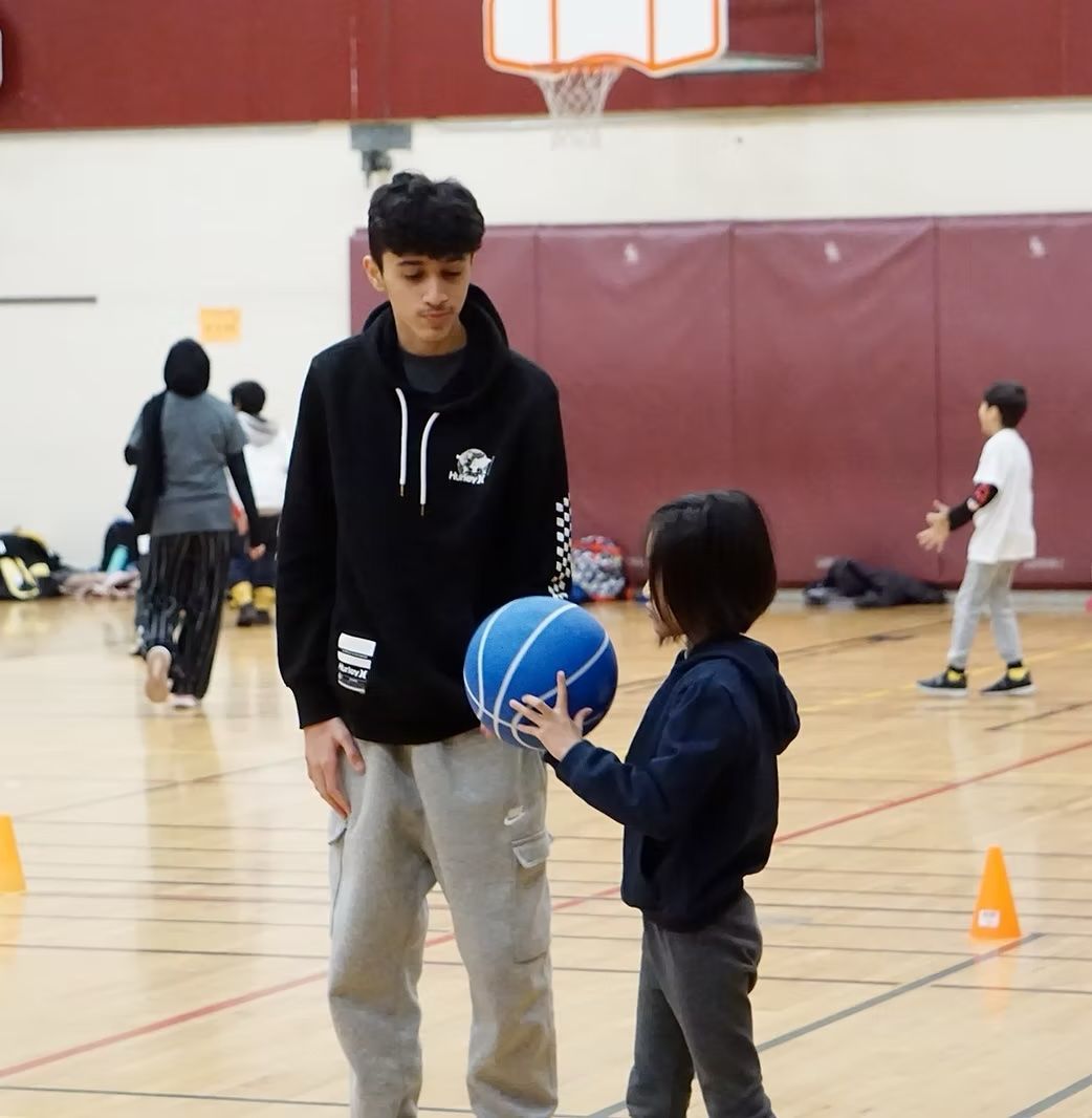 A boy in a black hoodie A boy in a black hoodie with the letter s on it