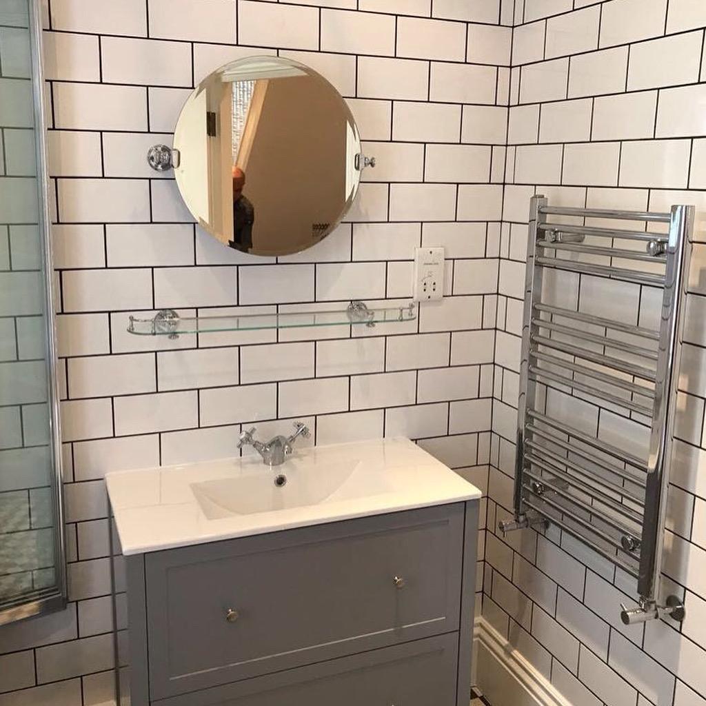 Tiled bathroom wall above sink