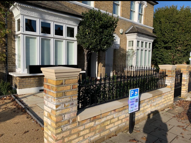completed brick wall with railings