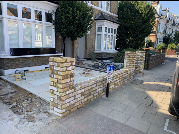 brick wall in front of a house