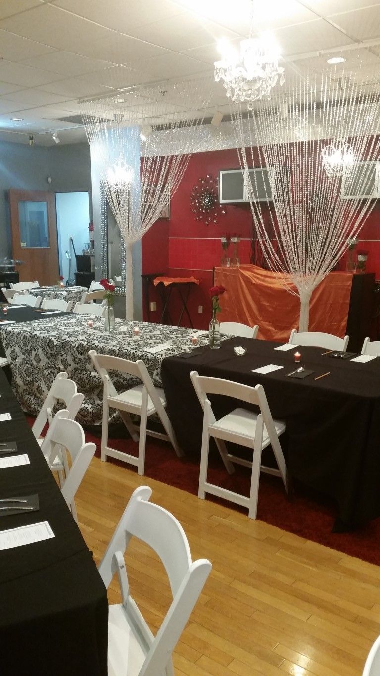 A room with tables and chairs set up for a party