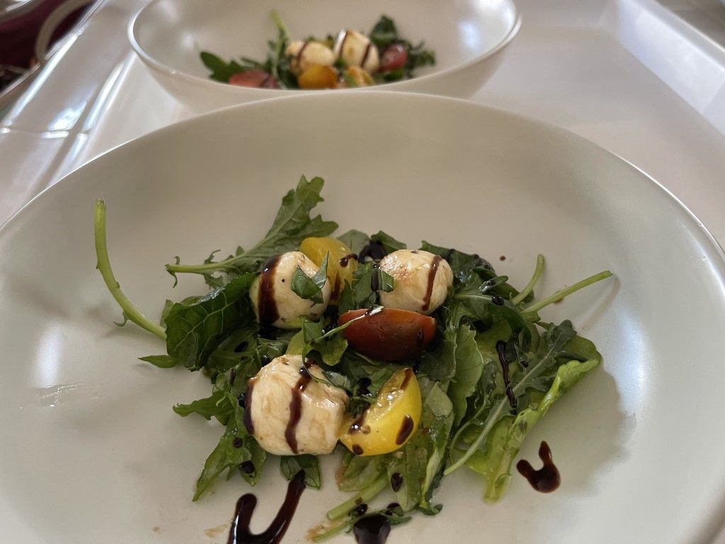 A close up of a salad on a plate on a table