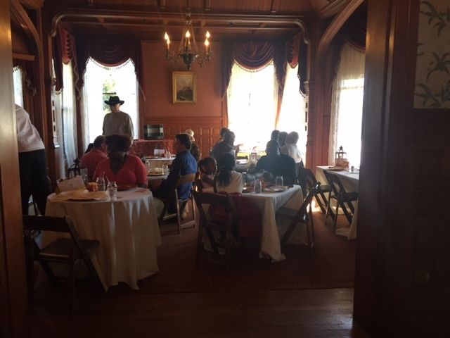 A group of people are sitting at tables in a room