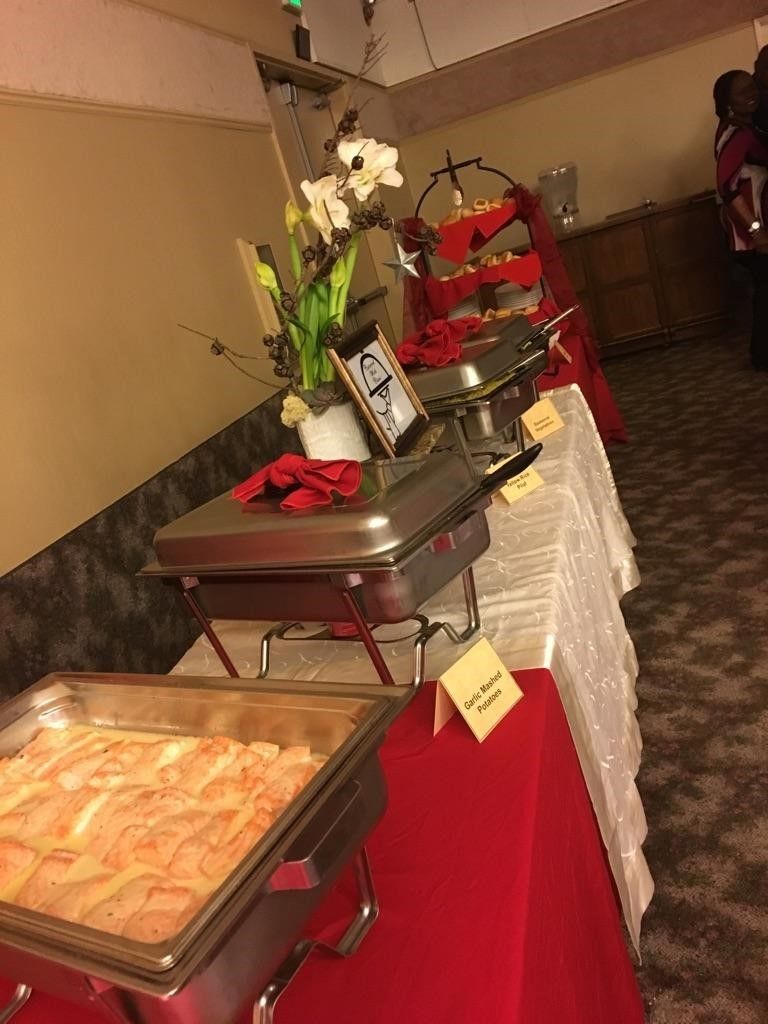 A buffet table with a tray of food on it