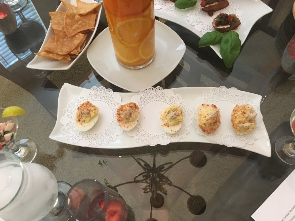 A table topped with plates of food and drinks.