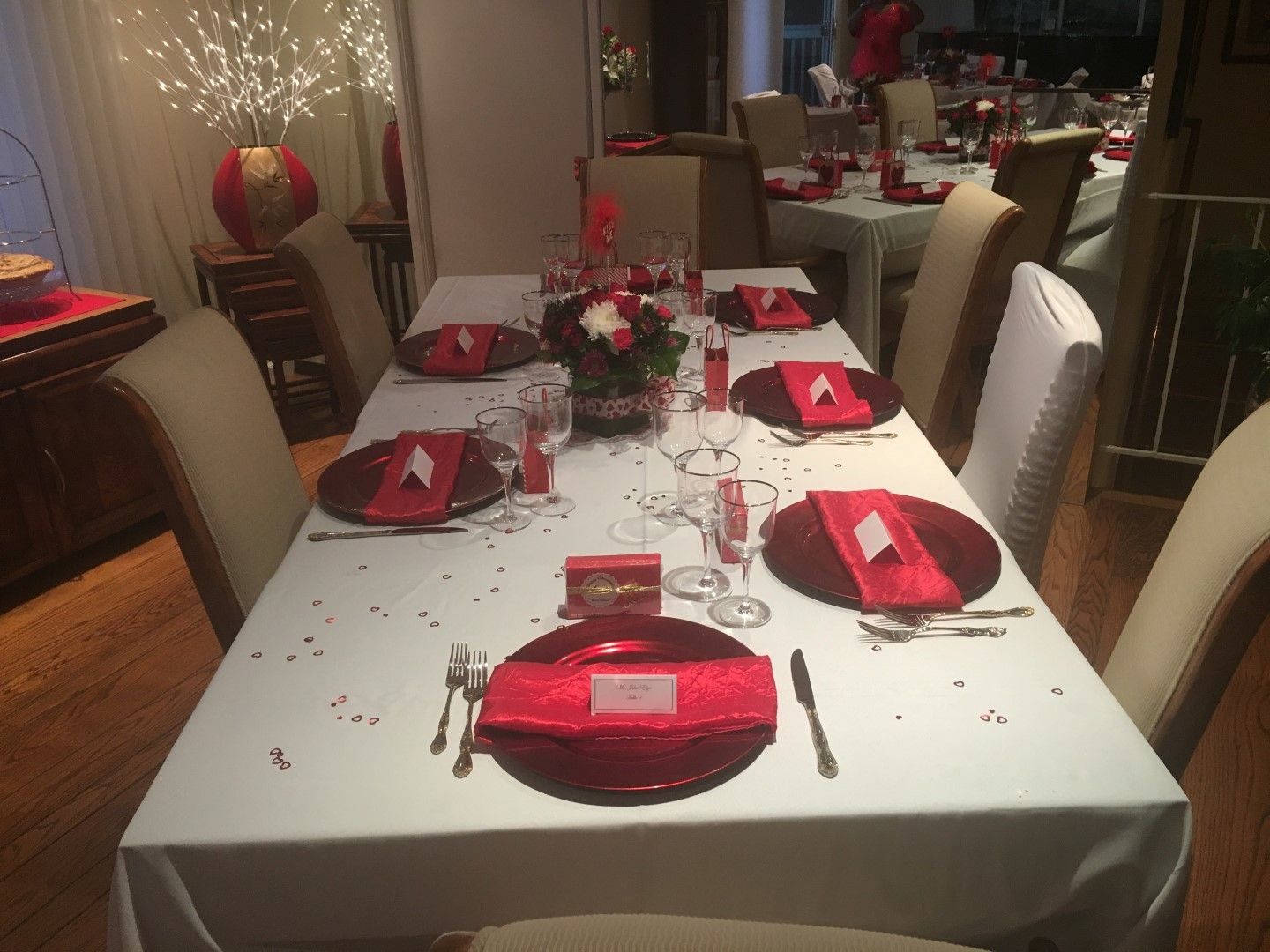 A long table with red napkins and plates on it