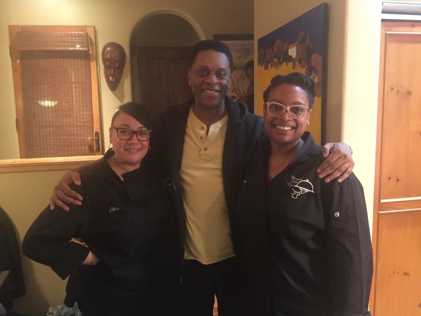 A man and two women kitchen staff