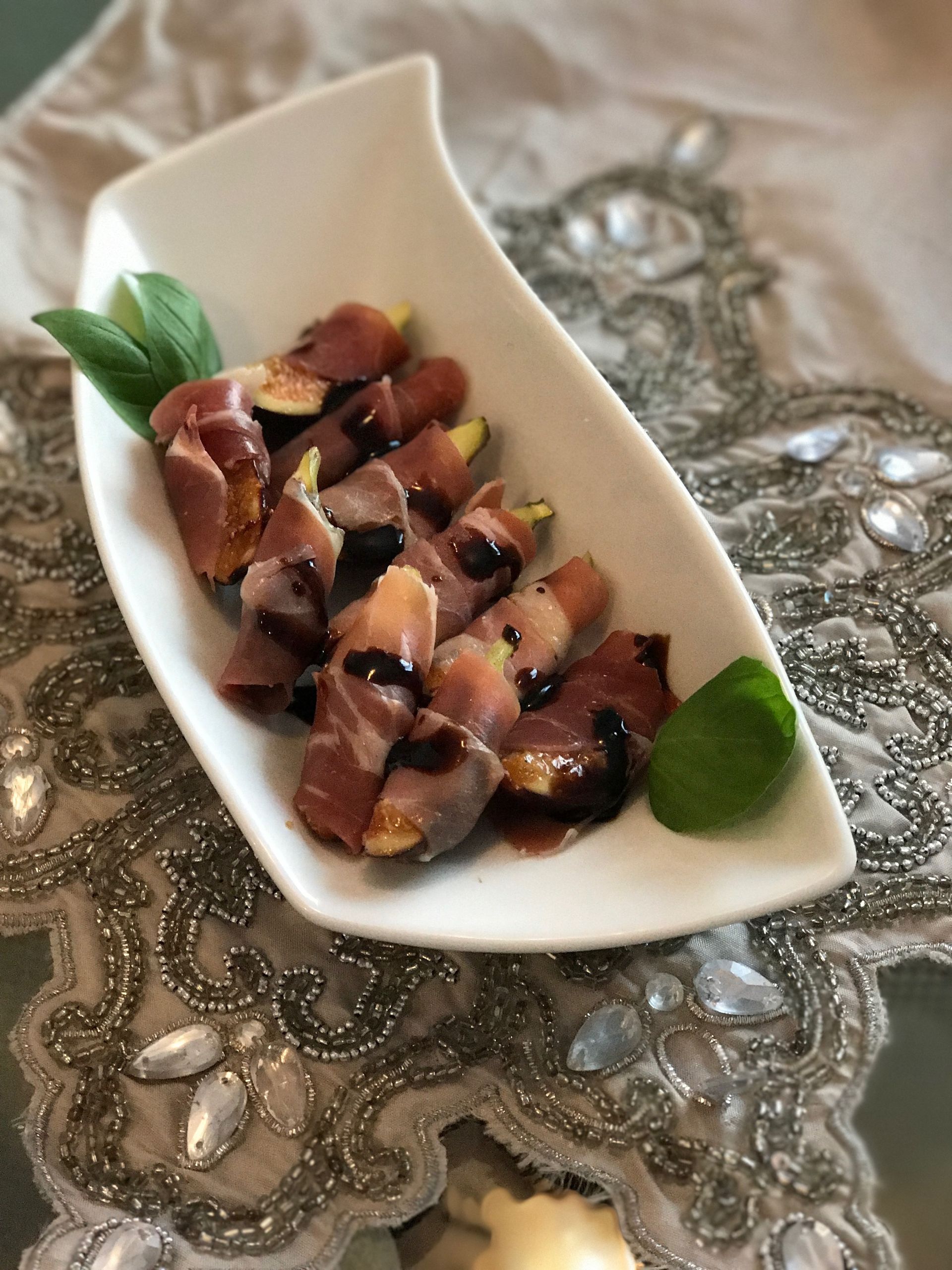 A white plate topped with meat and vegetables on a table