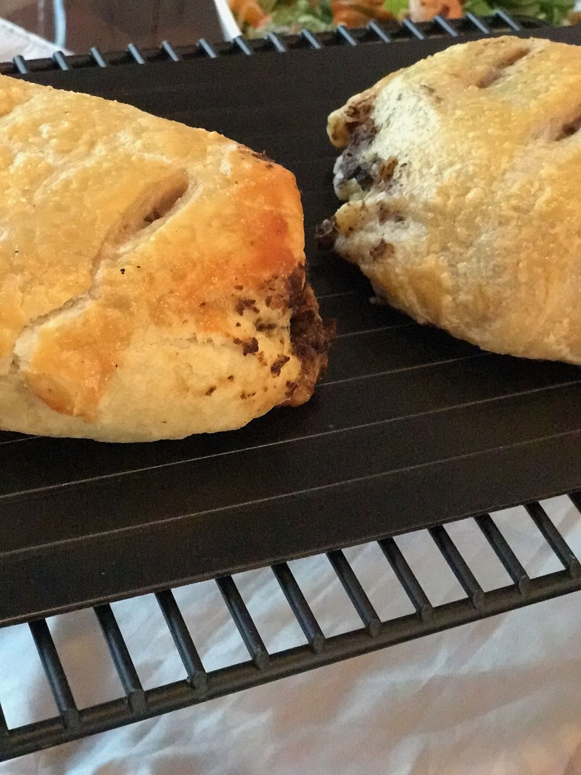 Two pastries are sitting on a cooling rack