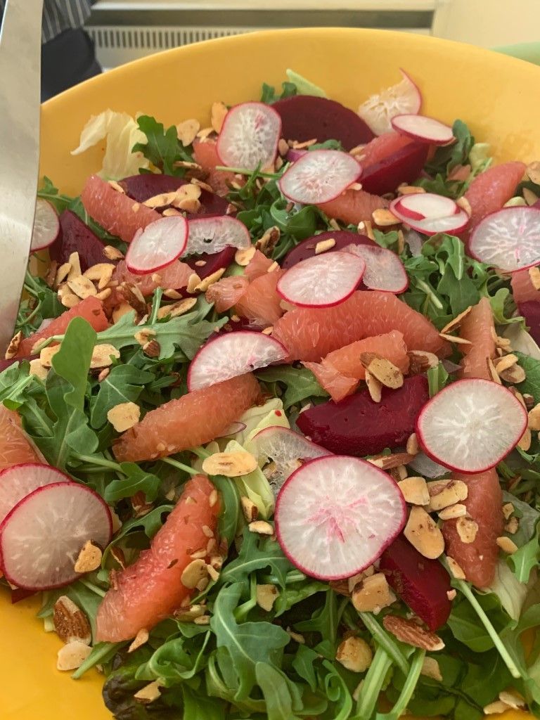 A close up of a salad on a yellow plate