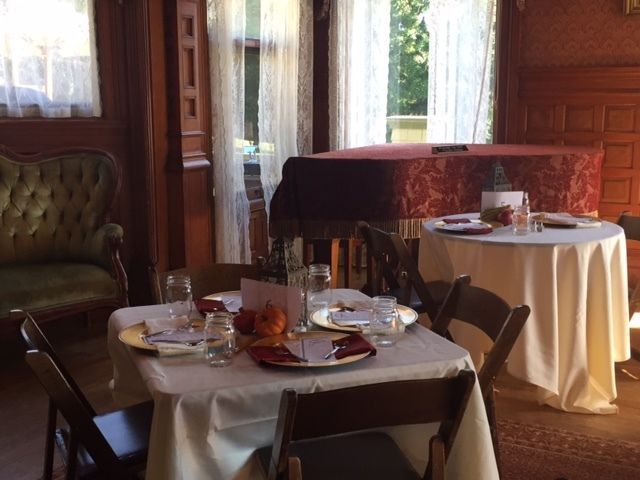 A room with tables and chairs and a piano