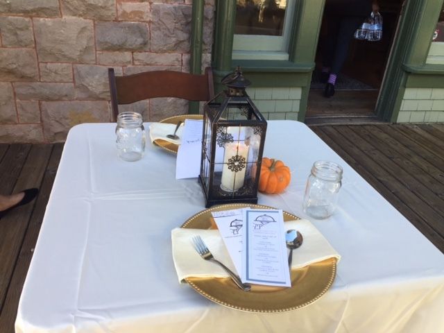 A table with plates and a lantern on it