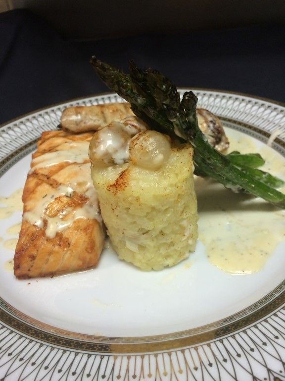 A plate of food with asparagus and mashed potatoes on it