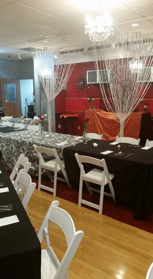 A room with tables and chairs set up for a party.