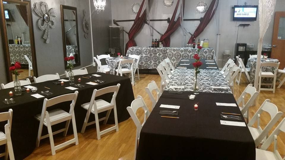 A room with tables and chairs set up for a party