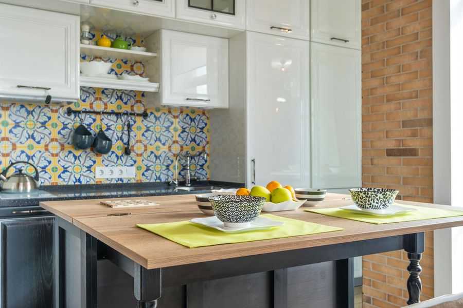 A split-view image showing a realistic kitchen blending into a white architectural line drawing.