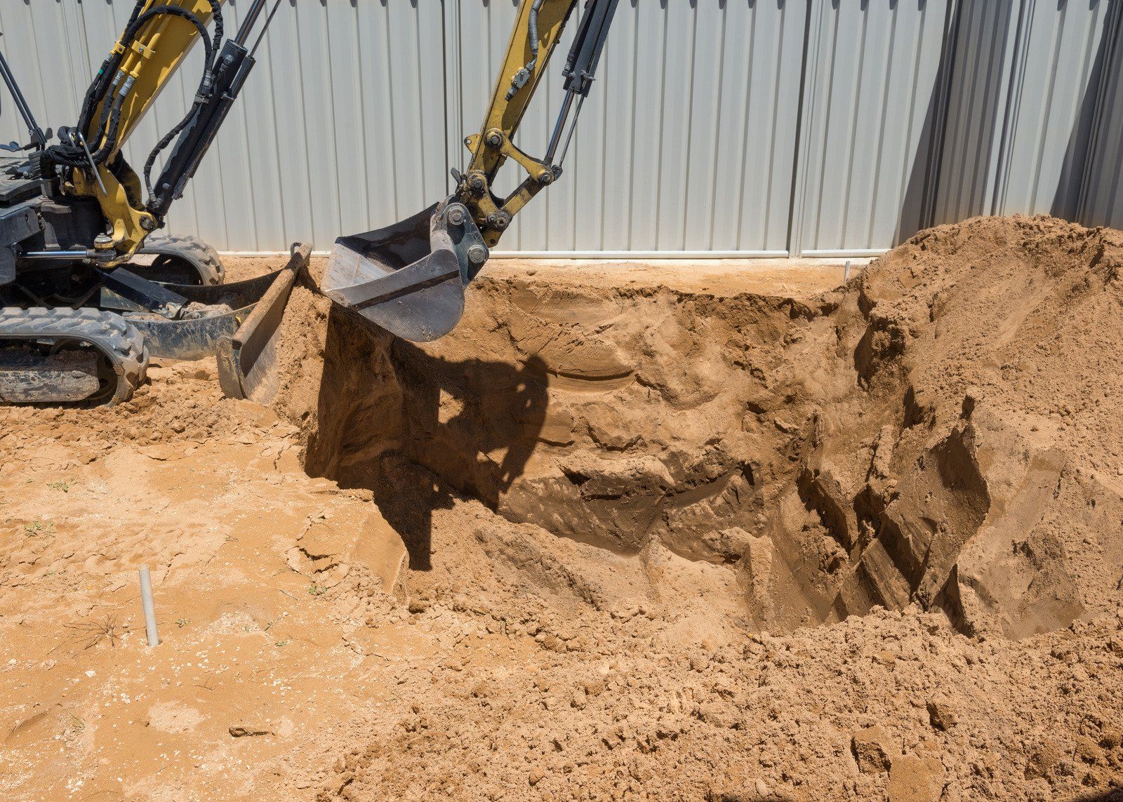Excavator digging a hole