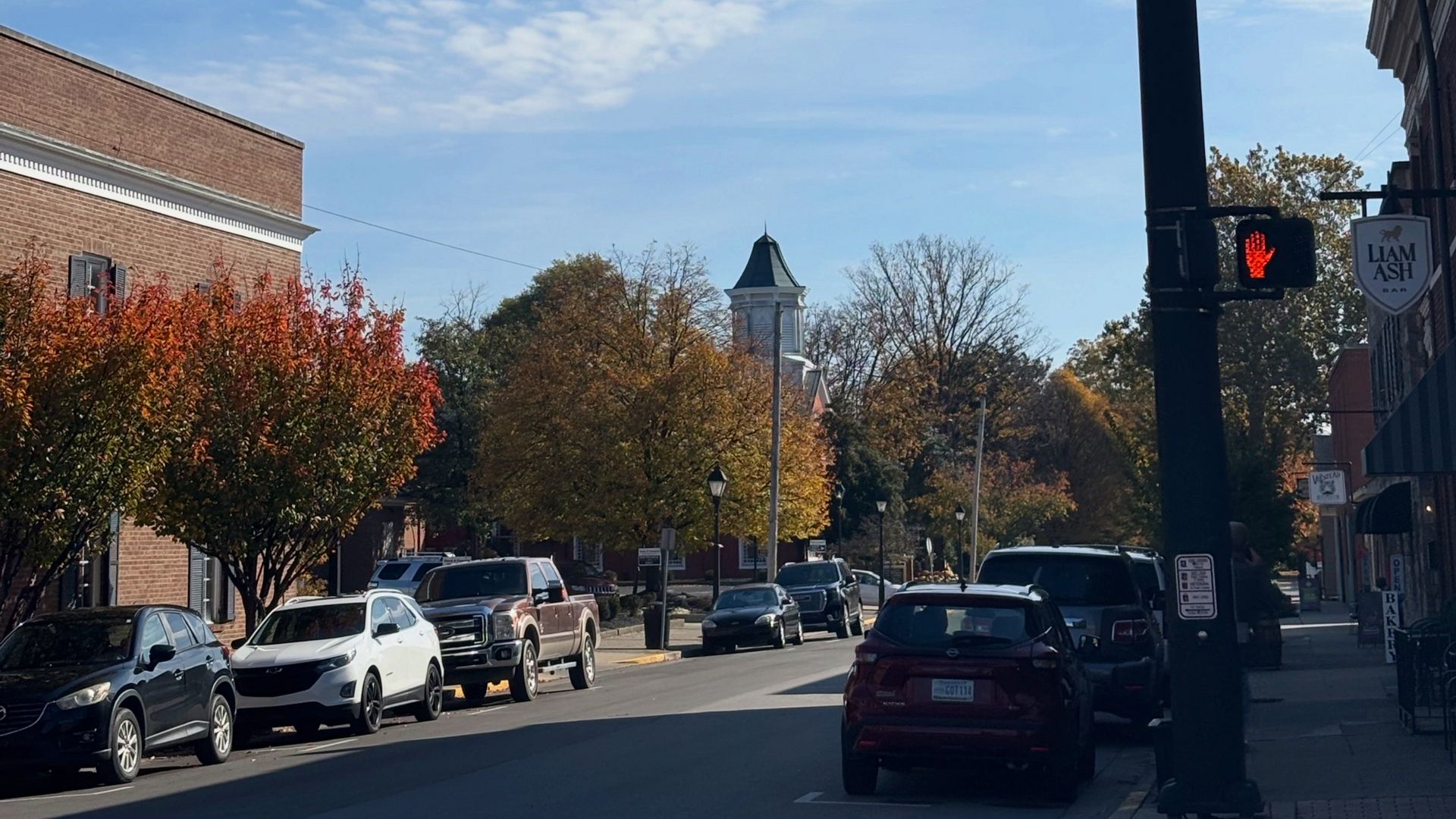 A lake with trees on the shore and trees reflected in the water