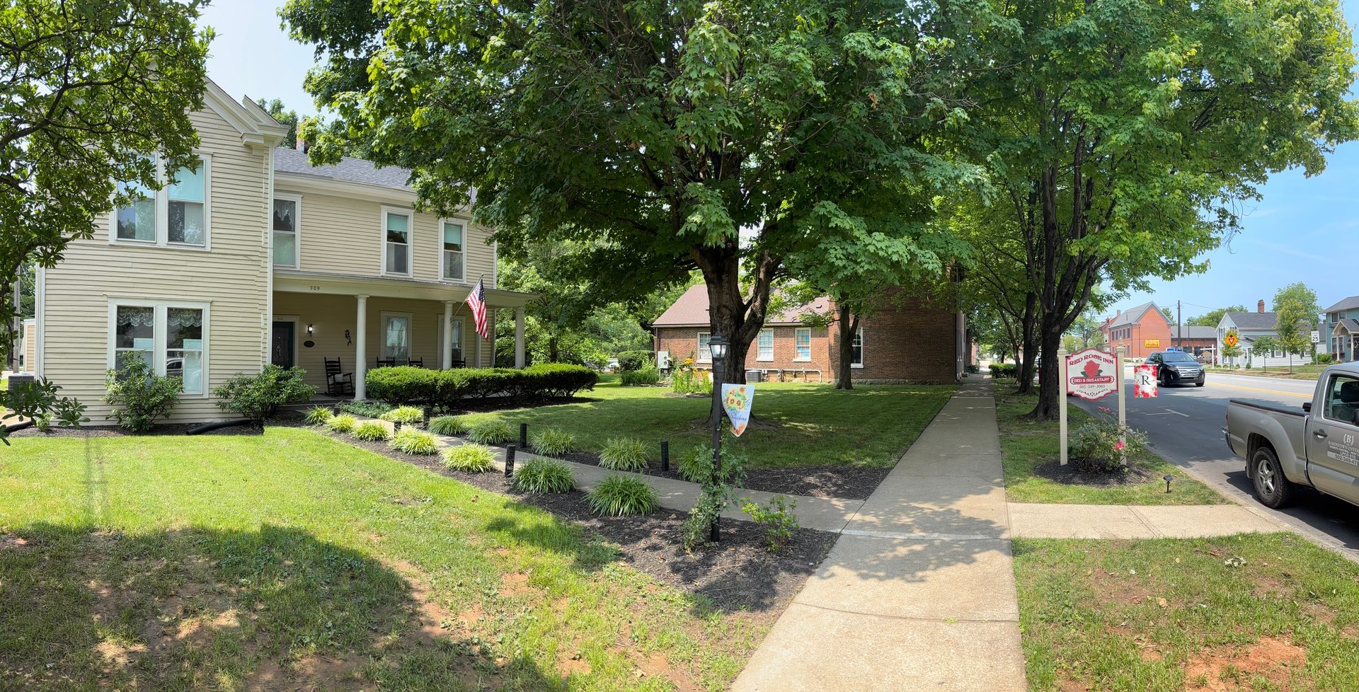 A living room with two red chairs and a luggage rack