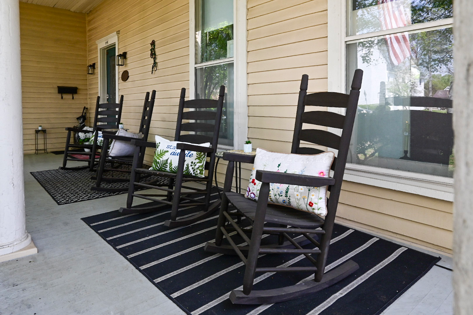 A living room with two red chairs and a luggage rack