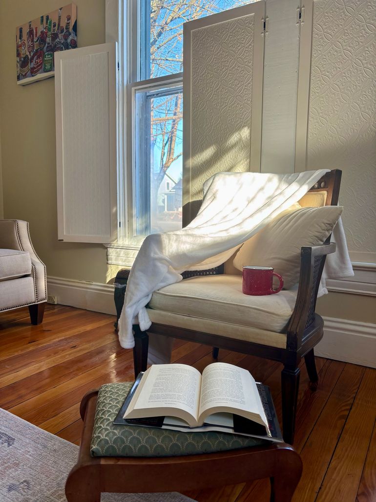 A living room with yellow walls and a fireplace