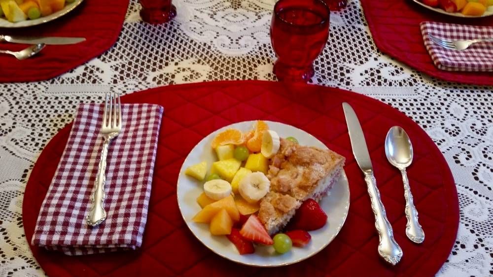 A plate of fruit and a piece of pie on a table