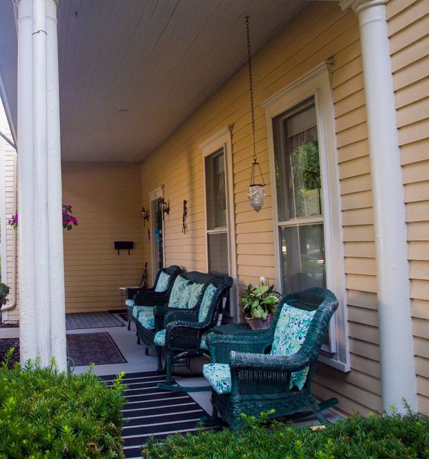 A porch with wicker chairs and a couch