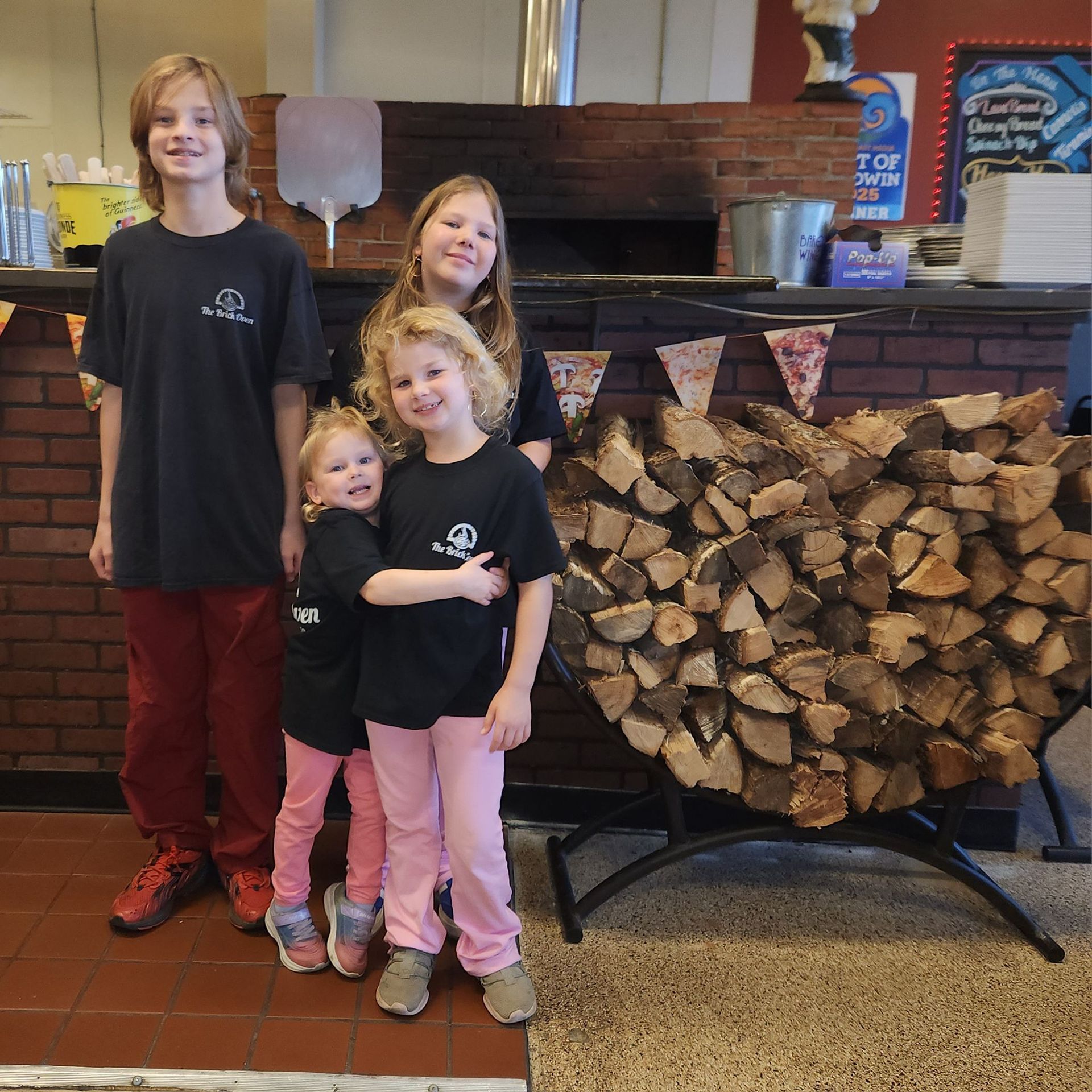Boy Holding Bakers Paddle Pizza — Delicious Italian Pizza in Foley, AL Boy Holding Bakers Paddle Pizza — Delicious Italian Pizza in Foley, AL