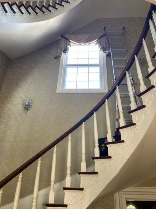 A spiral staircase in a house with a window