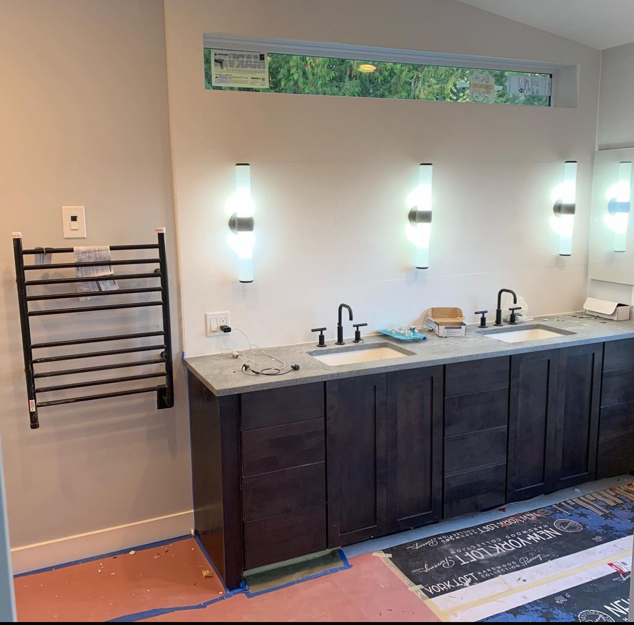 A bathroom with two sinks and a towel rack