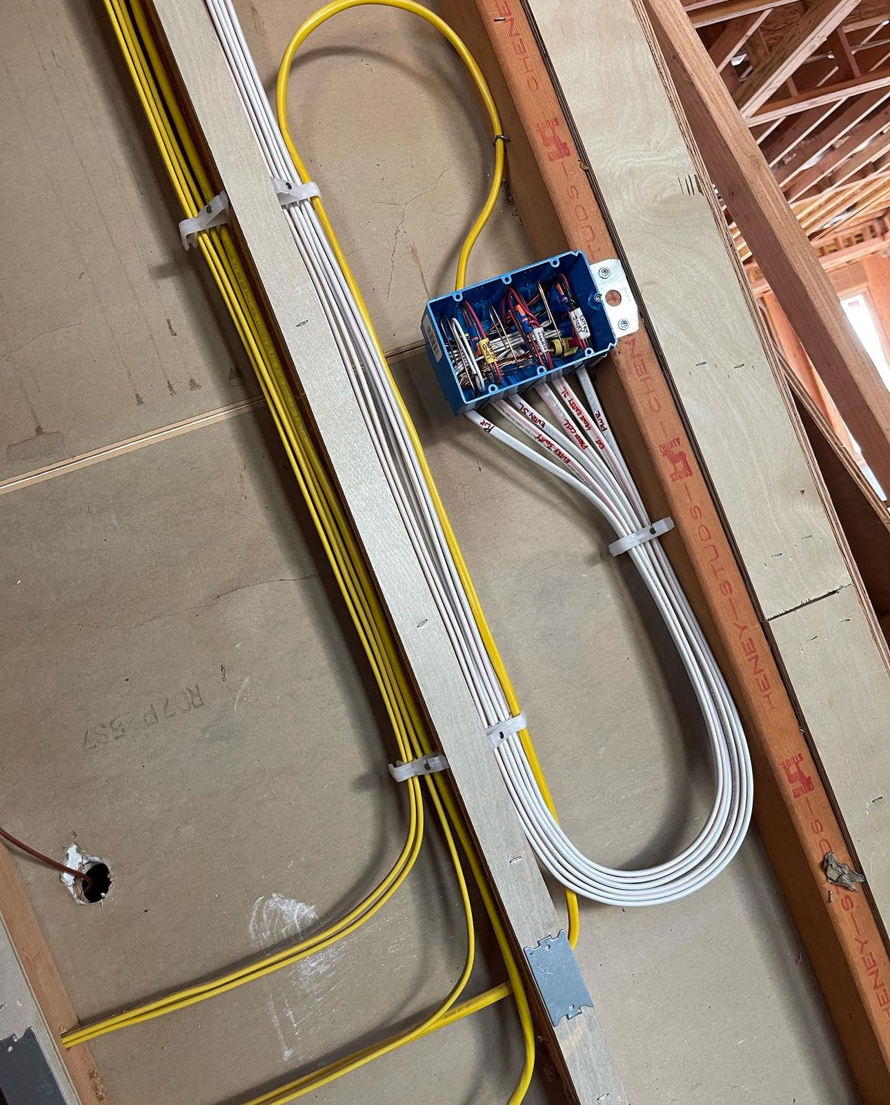 A bunch of wires are connected to a box on the wall