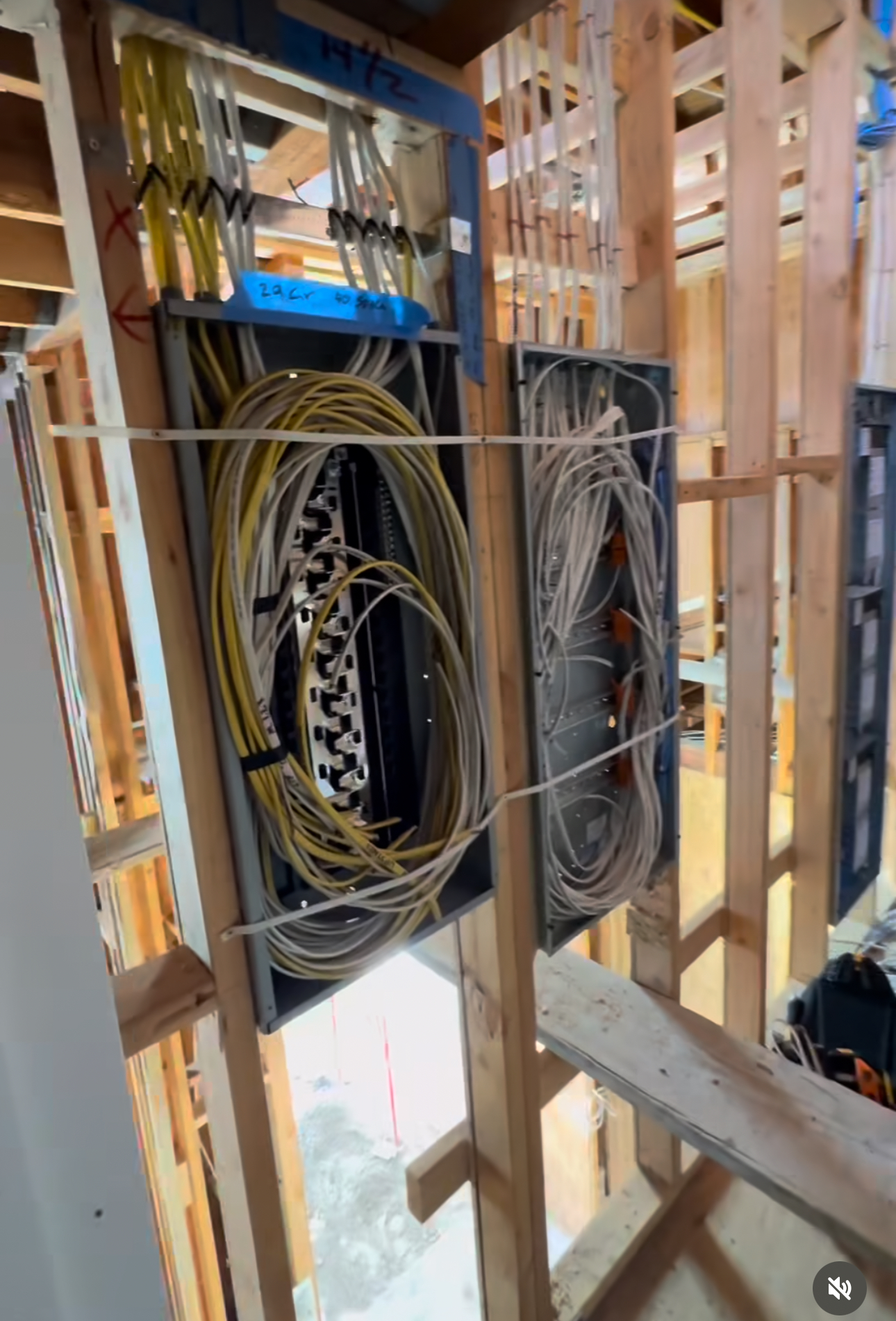 A bunch of wires are hanging from the ceiling of a building