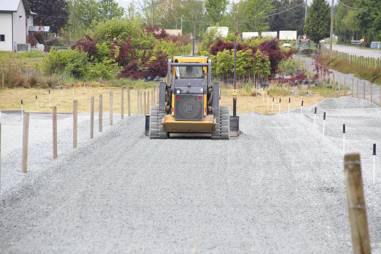 A bulldozer is driving down a gravel road.