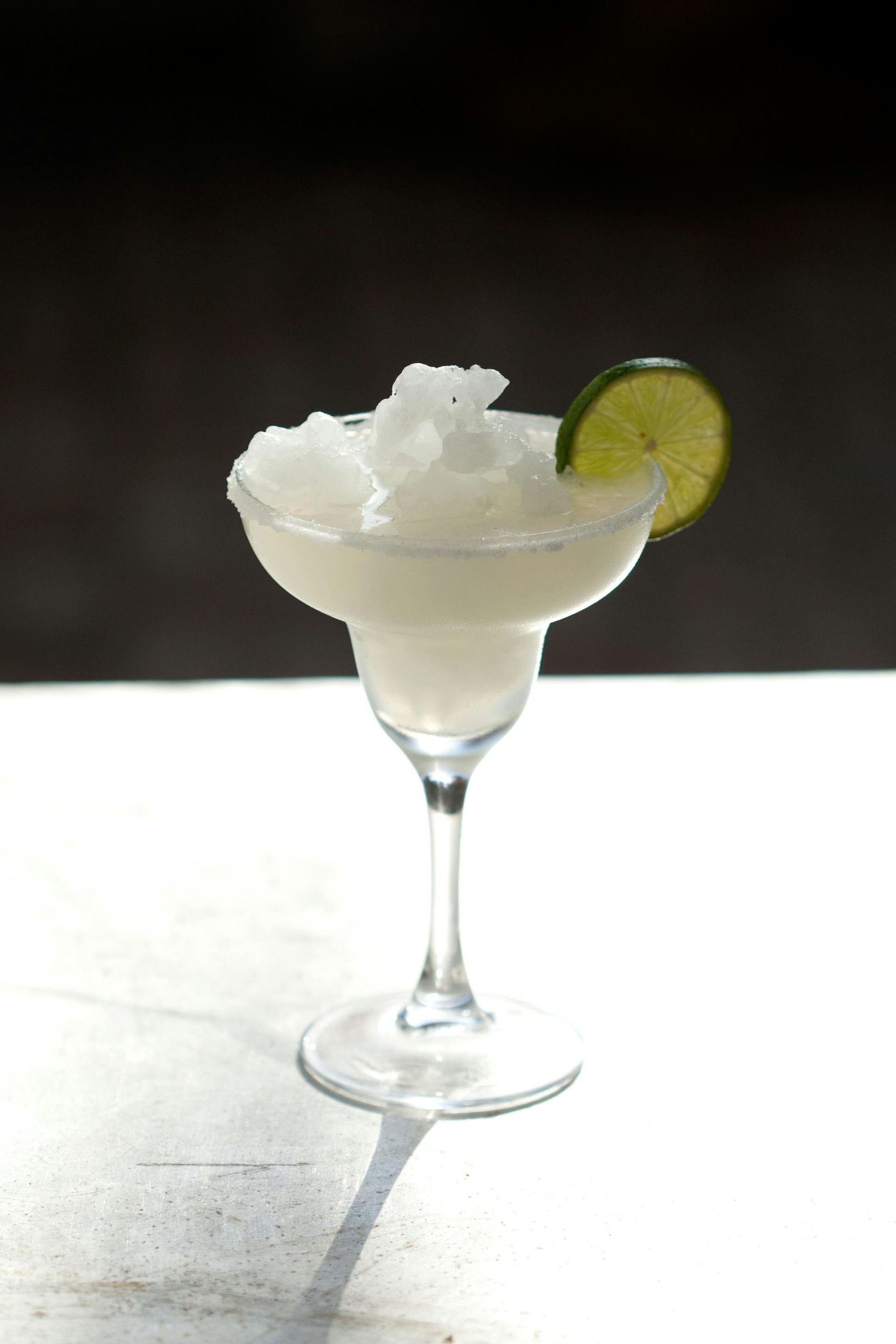 A frozen margarita with a slice of lime on top