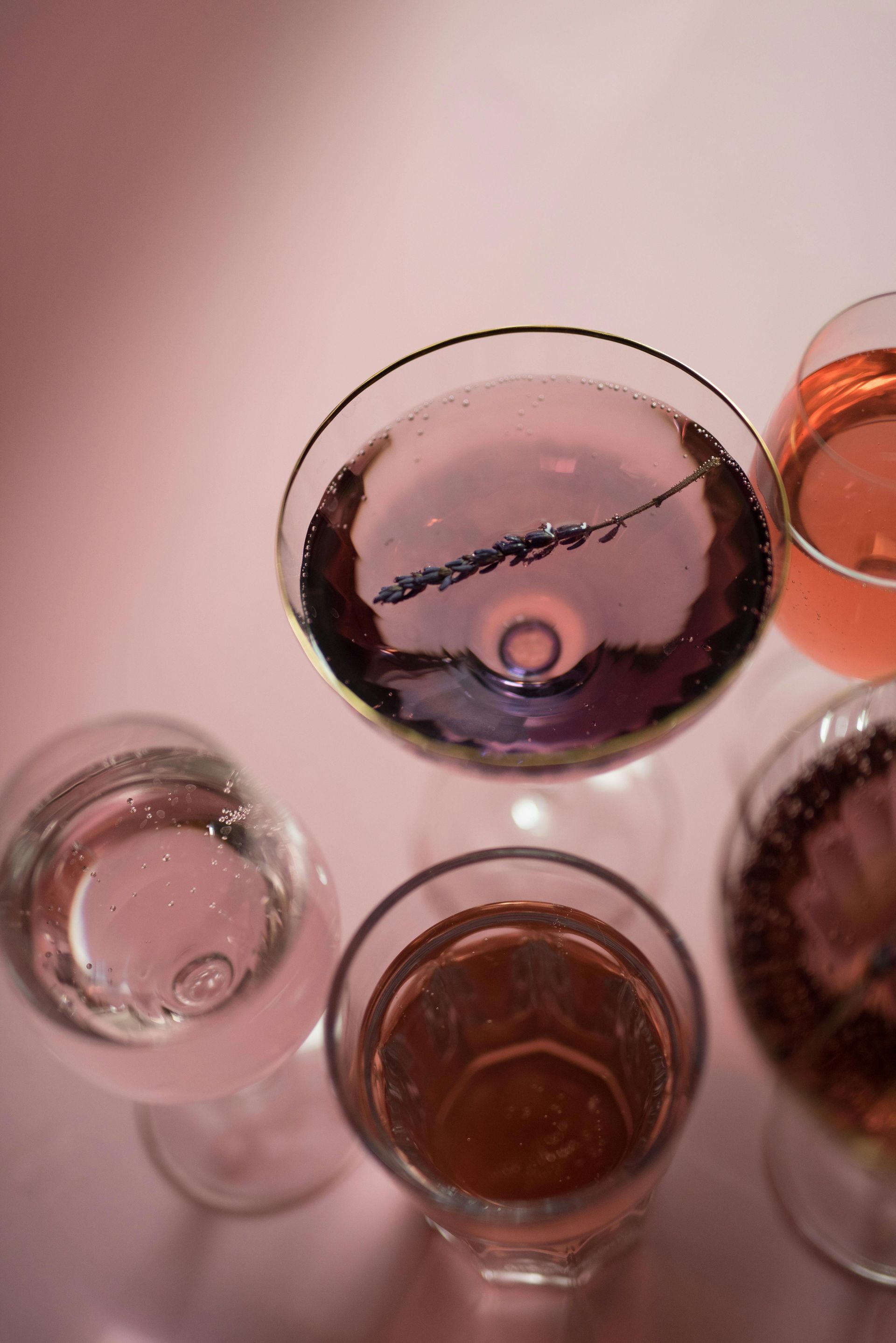 A group of wine glasses filled with different types of wine on a table.