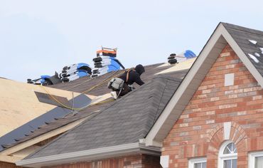 workers on roof performing a replacement