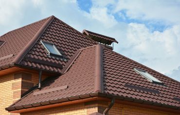 roof with brown metal roofing shingles