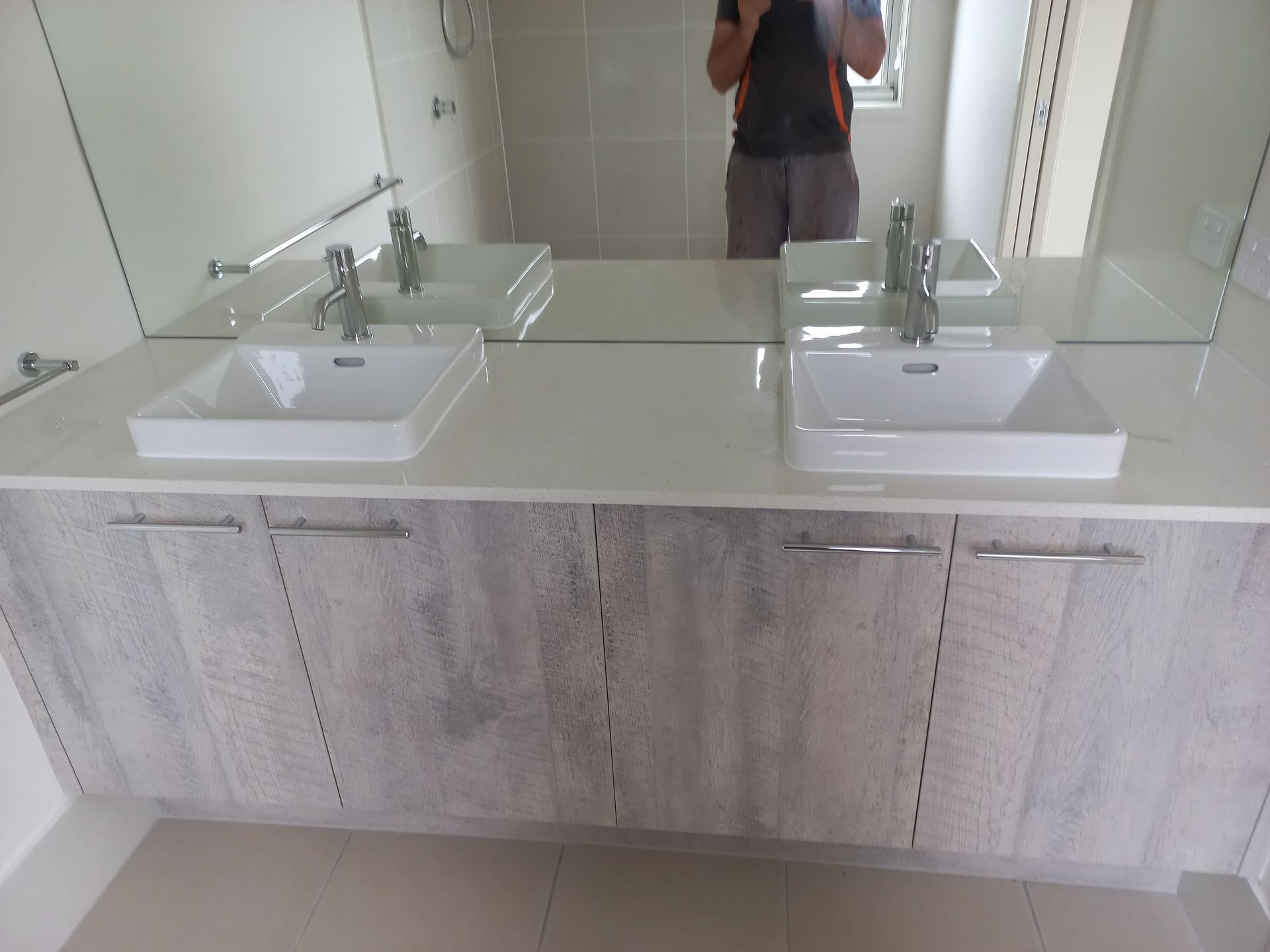 A Bathroom With Two Sinks and a Large Mirror — Bevan Plumbing in South Lismore, NSW