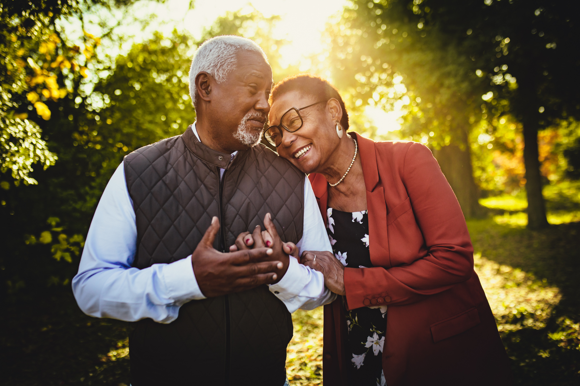 A man and a woman are standing with their arms in the air.